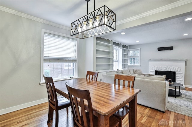 407 Claranna Ave, Oakwood, OH 45419 - dining room featuring hardwood / wood-style flooring, ornamental molding, a brick fireplace, and recessed lighting