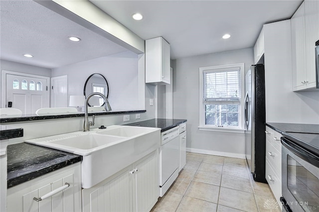 407 Claranna Ave, Oakwood, OH 45419 - kitchen featuring appliances with stainless steel finishes, light tile patterned flooring, healthy amount of natural light, white cabinets, and recessed lighting