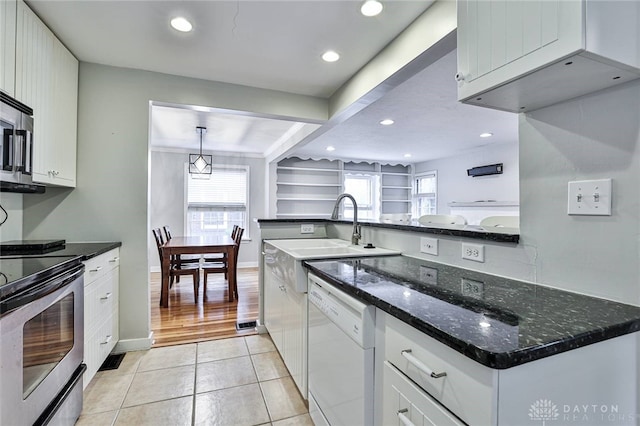 407 Claranna Ave, Oakwood, OH 45419 - kitchen with stainless steel appliances, white cabinets, dark stone countertops, light tile patterned floors, and recessed lighting