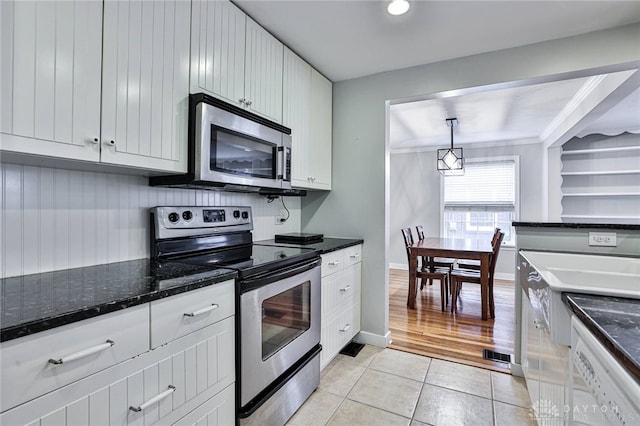 407 Claranna Ave, Oakwood, OH 45419 - kitchen featuring stainless steel appliances, light tile patterned floors, white cabinets, and dark stone countertops
