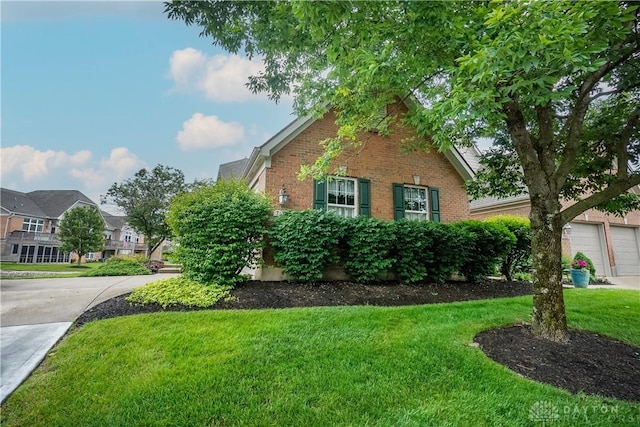 7516 Blue Fox Run, West Chester, OH 45069 - view of side of property featuring brick siding, a lawn, and a residential view