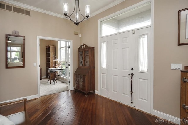7516 Blue Fox Run, West Chester, OH 45069 - entryway with a chandelier, plenty of natural light, dark wood-type flooring, and ornamental molding