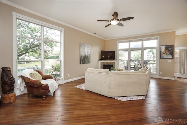 7516 Blue Fox Run, West Chester, OH 45069 - living area featuring ceiling fan, a fireplace, dark wood-style floors, ornamental molding, and plenty of natural light