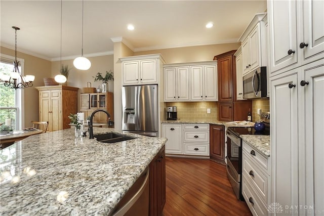 7516 Blue Fox Run, West Chester, OH 45069 - kitchen featuring appliances with stainless steel finishes, decorative backsplash, dark wood-type flooring, ornamental molding, and light stone countertops