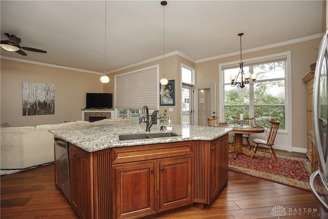 7516 Blue Fox Run, West Chester, OH 45069 - kitchen featuring dark wood finished floors, light stone countertops, ornamental molding, ceiling fan, and a center island with sink