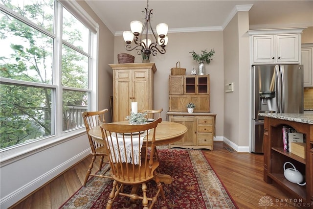 7516 Blue Fox Run, West Chester, OH 45069 - dining room featuring wood finished floors, ornamental molding, and a chandelier