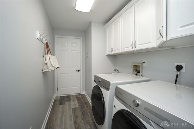 7516 Blue Fox Run, West Chester, OH 45069 - laundry area with cabinet space, washing machine and clothes dryer, and dark wood finished floors
