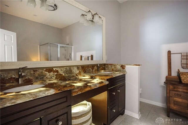 7516 Blue Fox Run, West Chester, OH 45069 - bathroom featuring a shower stall, double vanity, and tile patterned flooring