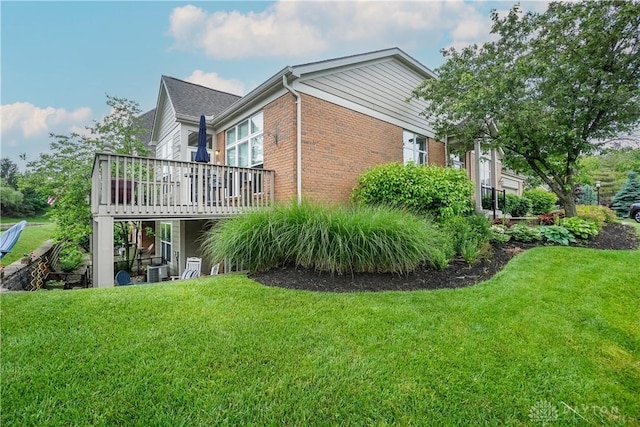 7516 Blue Fox Run, West Chester, OH 45069 - view of home's exterior featuring brick siding, a deck, and a lawn