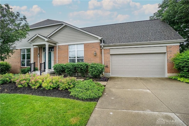 7516 Blue Fox Run, West Chester, OH 45069 - view of front facade featuring brick siding, an attached garage, concrete driveway, and a shingled roof
