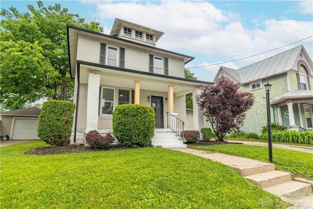 522 Pennsylvania Ave, Troy, OH 45373 - american foursquare style home featuring a front lawn, stucco siding, a porch, and a detached garage