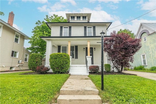 522 Pennsylvania Ave, Troy, OH 45373 - american foursquare style home featuring stucco siding, a porch, and a front lawn