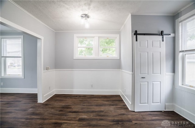 522 Pennsylvania Ave, Troy, OH 45373 - unfurnished room featuring ornamental molding, dark wood finished floors, baseboards, a barn door, and a textured ceiling