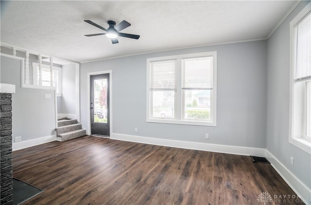 522 Pennsylvania Ave, Troy, OH 45373 - unfurnished living room with a ceiling fan, stairway, dark wood-type flooring, crown molding, and baseboards