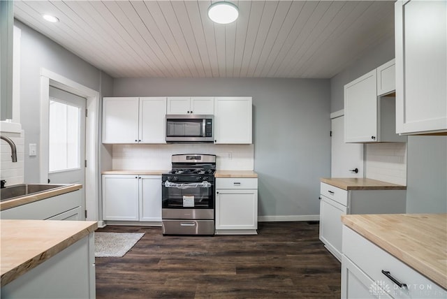 522 Pennsylvania Ave, Troy, OH 45373 - kitchen featuring appliances with stainless steel finishes, butcher block countertops, a sink, backsplash, and recessed lighting