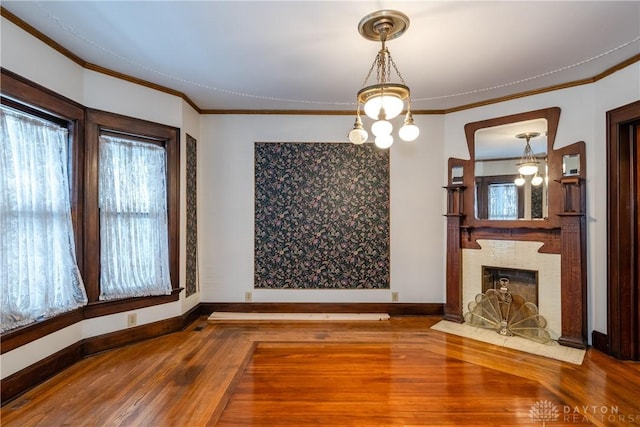 1628 E 5th St, Dayton, OH 45403 - unfurnished dining area featuring wood finished floors, ornamental molding, a fireplace, and baseboards