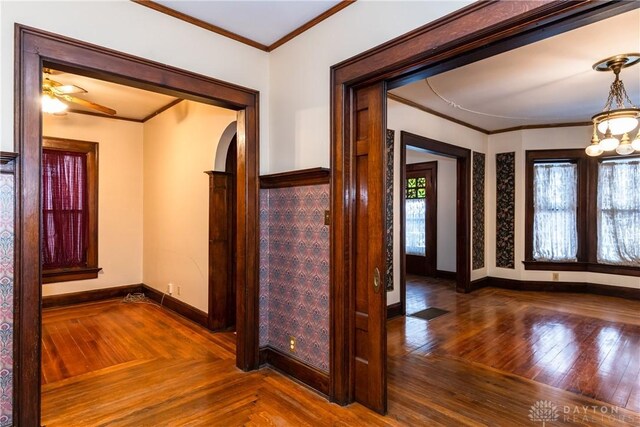 1628 E 5th St, Dayton, OH 45403 - foyer with crown molding, baseboards, parquet flooring, a ceiling fan, and arched walkways