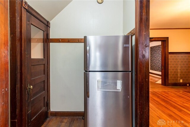 1628 E 5th St, Dayton, OH 45403 - kitchen with freestanding refrigerator, wood finished floors, vaulted ceiling, and baseboards