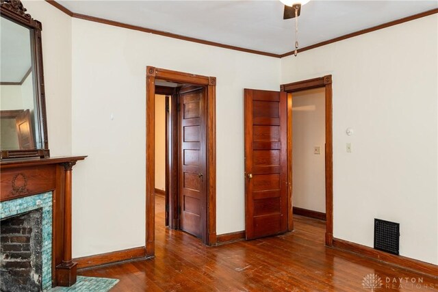 1628 E 5th St, Dayton, OH 45403 - unfurnished living room with baseboards, wood finished floors, crown molding, and a high end fireplace