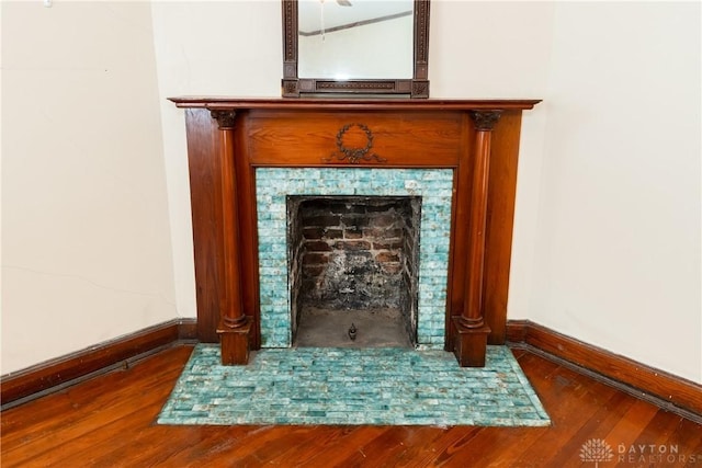 1628 E 5th St, Dayton, OH 45403 - detailed view of baseboards, wood finished floors, and a tile fireplace