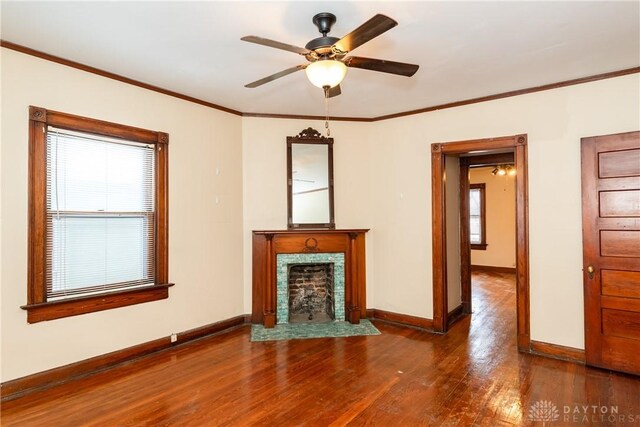 1628 E 5th St, Dayton, OH 45403 - unfurnished living room featuring baseboards, wood finished floors, plenty of natural light, and crown molding