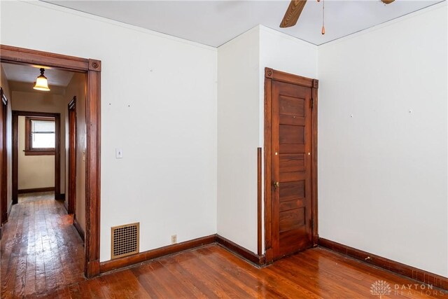 1628 E 5th St, Dayton, OH 45403 - spare room featuring dark wood-style floors, baseboards, and a ceiling fan
