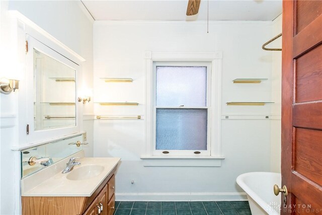 1628 E 5th St, Dayton, OH 45403 - full bath featuring vanity, a freestanding tub, baseboards, tile patterned floors, and ornamental molding