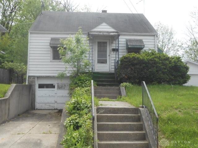 1202 Burt St, Springfield, OH 45505 - view of front of house featuring a garage, driveway, and stairway