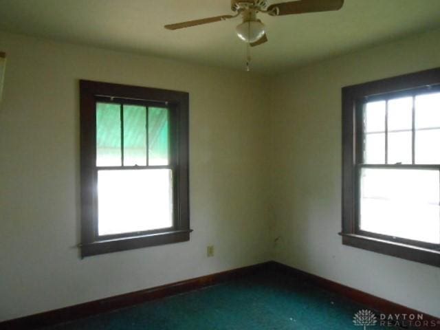 1202 Burt St, Springfield, OH 45505 - empty room featuring plenty of natural light, a ceiling fan, and baseboards