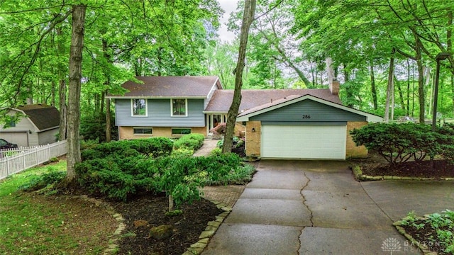 286 Honey Jane Dr, Beavercreek, OH 45434 - tri-level home featuring concrete driveway, a chimney, and an attached garage