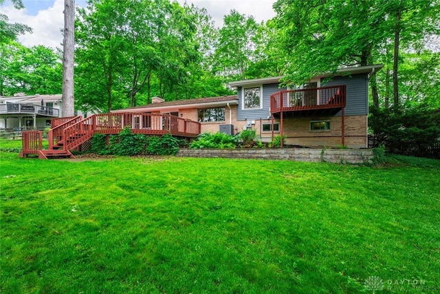 286 Honey Jane Dr, Beavercreek, OH 45434 - back of property featuring a deck, brick siding, and a lawn