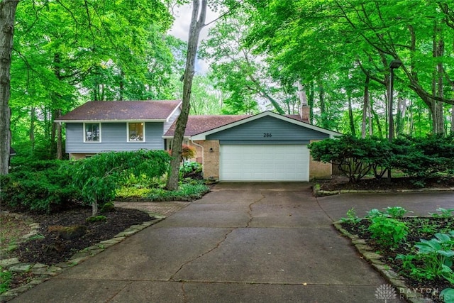 286 Honey Jane Dr, Beavercreek, OH 45434 - tri-level home with concrete driveway, brick siding, and a garage