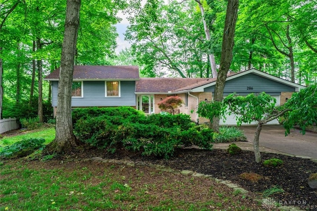 286 Honey Jane Dr, Beavercreek, OH 45434 - tri-level home with driveway, a garage, and brick siding