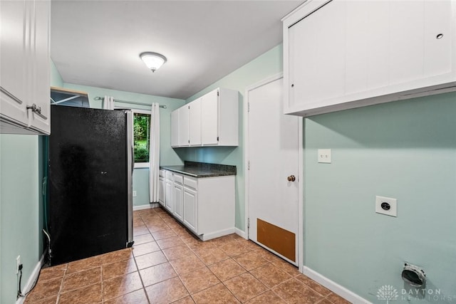 286 Honey Jane Dr, Beavercreek, OH 45434 - kitchen with freestanding refrigerator, white cabinets, baseboards, dark countertops, and light tile patterned flooring