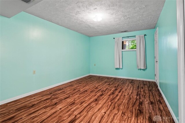 286 Honey Jane Dr, Beavercreek, OH 45434 - empty room featuring wood finished floors, baseboards, and a textured ceiling