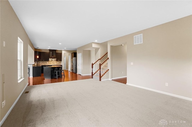 9752 Crooked Creek Dr, Centerville, OH 45458 - unfurnished living room featuring baseboards, stairs, recessed lighting, and dark colored carpet
