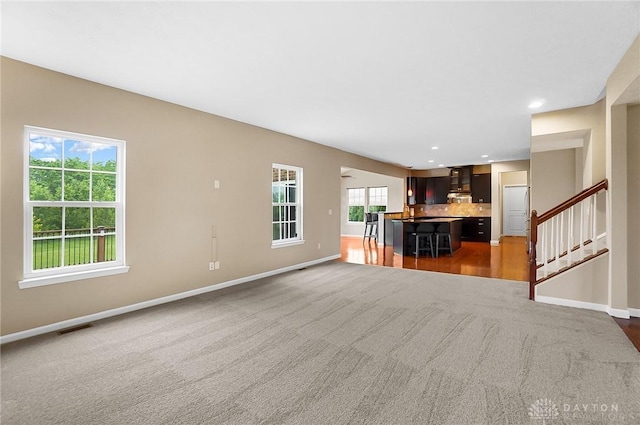 9752 Crooked Creek Dr, Centerville, OH 45458 - unfurnished living room with carpet, baseboards, stairway, and recessed lighting