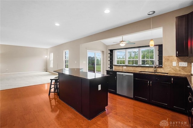9752 Crooked Creek Dr, Centerville, OH 45458 - kitchen featuring stainless steel dishwasher, a sink, open floor plan, a breakfast bar, and dark countertops
