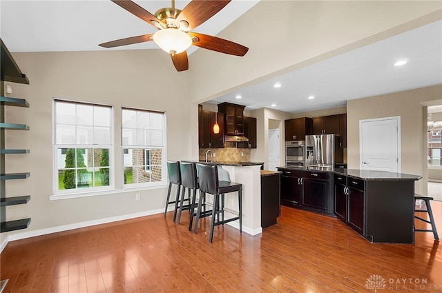 9752 Crooked Creek Dr, Centerville, OH 45458 - kitchen with stainless steel appliances, a kitchen bar, healthy amount of natural light, a ceiling fan, and recessed lighting