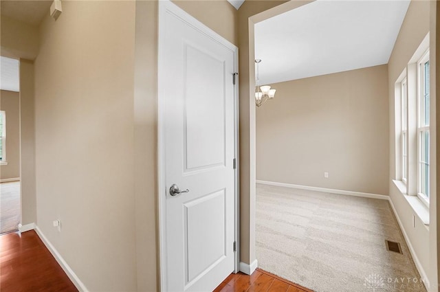 9752 Crooked Creek Dr, Centerville, OH 45458 - hall with a chandelier, baseboards, and wood finished floors