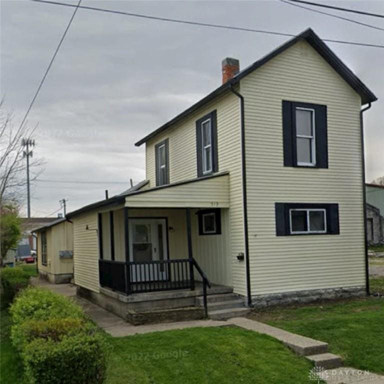 519 Miami St, Piqua, OH 45356 - view of front of home with a porch, a front lawn, and a chimney