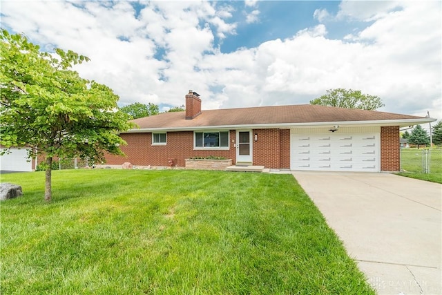 692 Sueden Dr, Beavercreek, OH 45430 - ranch-style home with an attached garage, a chimney, driveway, and a front yard