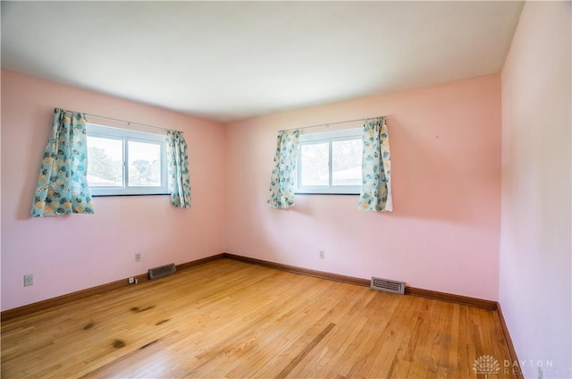 692 Sueden Dr, Beavercreek, OH 45430 - spare room featuring plenty of natural light, light wood finished floors, and baseboards