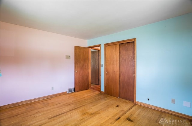 692 Sueden Dr, Beavercreek, OH 45430 - unfurnished bedroom with light wood-type flooring, a closet, and baseboards