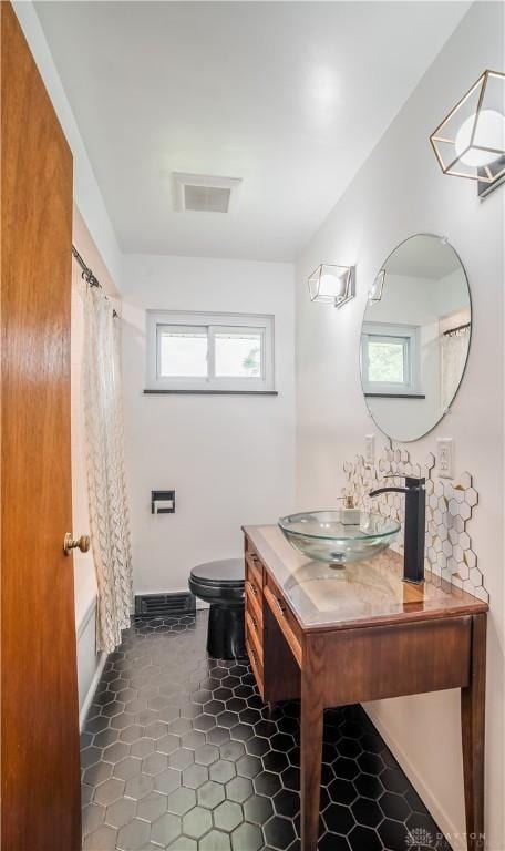 692 Sueden Dr, Beavercreek, OH 45430 - bathroom with vanity, toilet, and shower / bath combo with shower curtain