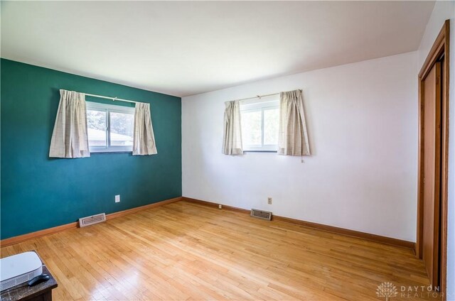 692 Sueden Dr, Beavercreek, OH 45430 - unfurnished bedroom with wood finished floors, baseboards, and a closet