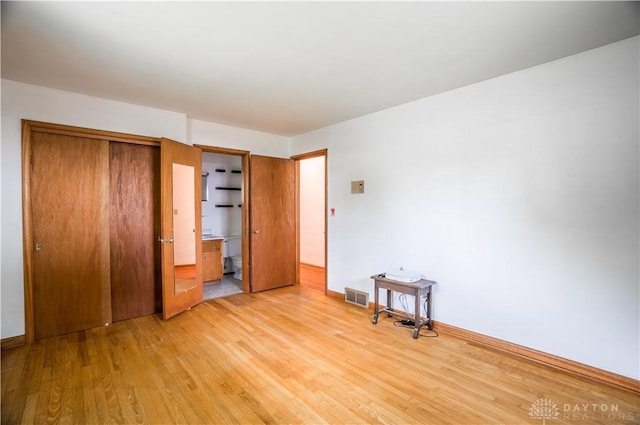 692 Sueden Dr, Beavercreek, OH 45430 - unfurnished bedroom featuring light wood-style flooring, baseboards, a closet, and connected bathroom