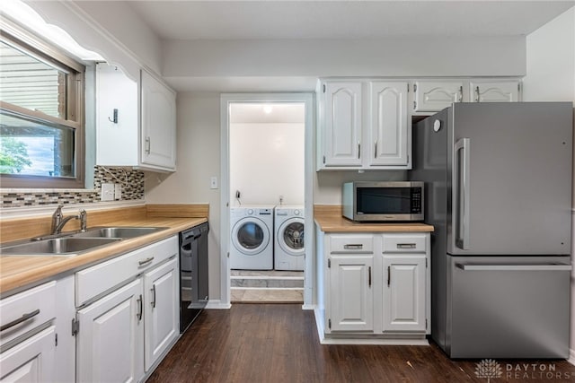 3558 Knollbrook Dr, Franklin Twp, OH 45005 - kitchen with appliances with stainless steel finishes, washer and clothes dryer, a sink, white cabinetry, and dark wood-style flooring