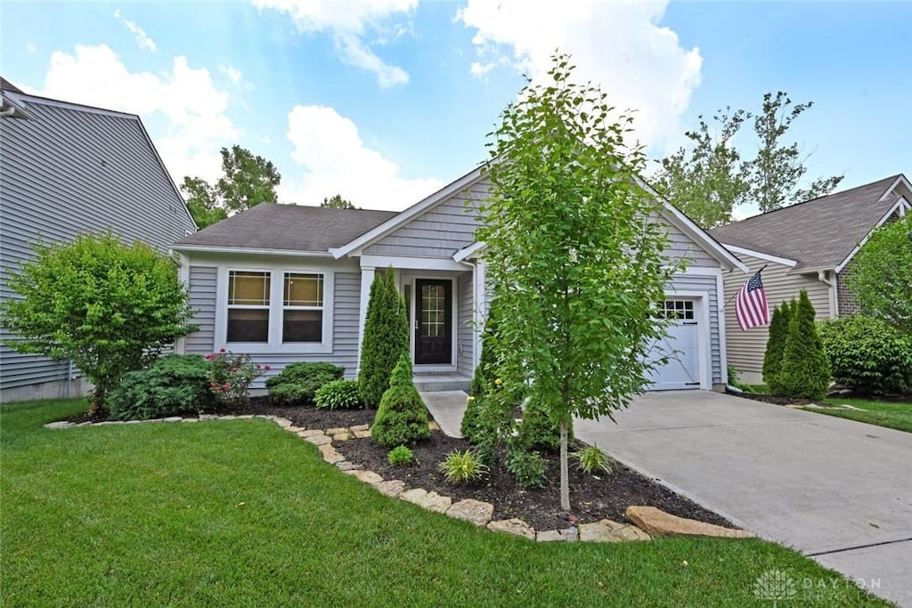 4197 Black Bear Dr, Lebanon, OH 45036 - view of front of home featuring an attached garage, concrete driveway, and a front lawn