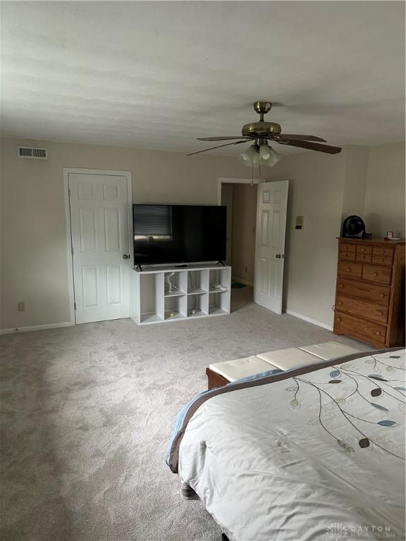 2419 Meadow Green Dr, Beavercreek, OH 45431 - bedroom with baseboards, carpet floors, and a ceiling fan